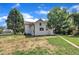 View of the backyard featuring a white home, a brick walkway and mature shade trees at 305 W Canary St, Dunn, NC 28334