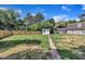Spacious backyard with a brick path, shed, lush lawn, and wooden fence at 305 W Canary St, Dunn, NC 28334