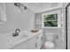 Chic bathroom featuring white cabinetry, modern fixtures, and a window with a serene outdoor view at 305 W Canary St, Dunn, NC 28334