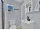 Cozy bathroom with gray-blue walls, white fixtures, and a mirrored medicine cabinet at 305 W Canary St, Dunn, NC 28334