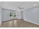 Bedroom with wood-look floors, two windows and light blue walls at 305 W Canary St, Dunn, NC 28334