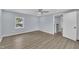 Well-lit bedroom with wood-look floors, ceiling fan and hallway access at 305 W Canary St, Dunn, NC 28334
