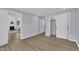A bright bedroom featuring wood floors, closet and a view into the living room at 305 W Canary St, Dunn, NC 28334
