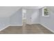 Light-filled bedroom with wood-look flooring and an open doorway to the hall at 305 W Canary St, Dunn, NC 28334