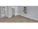 A bedroom showcasing light blue walls, a closet, and hardwood floors, with a view to the outside at 305 W Canary St, Dunn, NC 28334