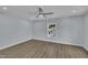 Bright bedroom with wood-look floors, ceiling fan and a large window view at 305 W Canary St, Dunn, NC 28334