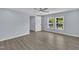 Airy bedroom with wood-look floors, ceiling fan and two windows for ample sunlight at 305 W Canary St, Dunn, NC 28334