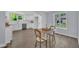 Bright dining area next to kitchen features refinished wood floors and natural light from two windows at 305 W Canary St, Dunn, NC 28334