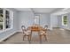Bright dining room features light walls, wood floors, and lots of natural light from two windows at 305 W Canary St, Dunn, NC 28334