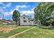 Charming two-story home featuring a manicured lawn, a brick walkway, and lush trees at 305 W Canary St, Dunn, NC 28334