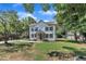 Exterior view of a charming two-story home, showcasing board and batten siding and a well-kept front yard at 305 W Canary St, Dunn, NC 28334