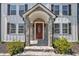 Close-up of the home's front entrance, highlighting the stone archway and the red front door at 305 W Canary St, Dunn, NC 28334