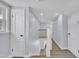 Well-lit hallway with white doors and trim, leading to the upper level of the home at 305 W Canary St, Dunn, NC 28334