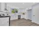 Spacious kitchen equipped with white cabinetry, stainless steel appliances, and an open, airy layout at 305 W Canary St, Dunn, NC 28334