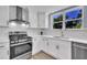 Bright kitchen featuring white cabinetry, stainless steel appliances, and a window with a view at 305 W Canary St, Dunn, NC 28334