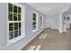 Bright living room features light walls, wood floors, and lots of natural light from three windows at 305 W Canary St, Dunn, NC 28334