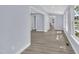 Bright living room features light walls, wood floors, and lots of natural light from sunroom at 305 W Canary St, Dunn, NC 28334