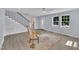 Bright living room features refinished wood floors, a ceiling fan, and natural light from two windows at 305 W Canary St, Dunn, NC 28334