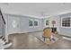 Bright living room features refinished wood floors, a ceiling fan, fireplace and natural light at 305 W Canary St, Dunn, NC 28334