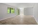 Open-concept living room with sliding glass doors and large windows showcasing natural light at 3088 Colony Rd # A, Durham, NC 27705