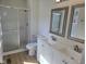 This bathroom features a tiled shower with sliding glass doors and a double vanity at 309 Wyatts Pond Lane, Cary, NC 27513