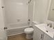The bathroom features a tub/shower combo with white tiling, wood-look flooring and a modern vanity with sink at 309 Wyatts Pond Lane, Cary, NC 27513