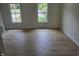 Spacious bedroom area features modern light wood floors and natural light from two windows at 309 Wyatts Pond Lane, Cary, NC 27513