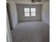 This spacious bedroom features neutral carpeting and a window for natural light at 309 Wyatts Pond Lane, Cary, NC 27513