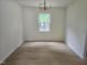 Dining room with hardwood floors and a window providing an abundance of natural light at 309 Wyatts Pond Lane, Cary, NC 27513