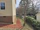 Side view of home with brick foundation and mulch bed near the house at 309 Wyatts Pond Lane, Cary, NC 27513