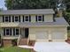 Charming two-story home featuring a well-manicured lawn, brick steps, and an attached two-car garage at 309 Wyatts Pond Lane, Cary, NC 27513