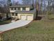 Two story home with two car garage, double hung windows, and large driveway at 309 Wyatts Pond Lane, Cary, NC 27513