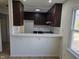 Charming kitchen with stainless steel appliances, bright countertops, and dark cabinetry at 309 Wyatts Pond Lane, Cary, NC 27513