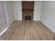 Spacious living room with a classic brick fireplace and modern flooring at 309 Wyatts Pond Lane, Cary, NC 27513