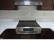 Updated electric range with stainless steel accents and overhead vent at 309 Wyatts Pond Lane, Cary, NC 27513