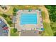 Aerial view of a community swimming pool with lounge chairs and umbrellas for relaxation at 31 Pascoli Ct, Clayton, NC 27527