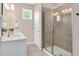 This bathroom has a glass shower, white cabinets, and one window at 31 Pascoli Ct, Clayton, NC 27527
