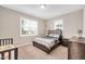 Neutral bedroom with a bed between two windows, dresser, and bassinet at 31 Pascoli Ct, Clayton, NC 27527