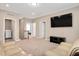 Expansive bonus room with large flat screen TV, sofa, and nearby laundry room at 31 Pascoli Ct, Clayton, NC 27527