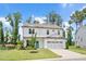 Charming two-story home featuring a bright blue front door, well-manicured lawn and attached two-car garage at 31 Pascoli Ct, Clayton, NC 27527