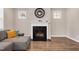 Elegant fireplace with decorative clock and white mantle, surrounded by natural light at 31 Pascoli Ct, Clayton, NC 27527