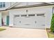 Spacious two-car garage door with decorative hardware on a well-maintained home exterior at 31 Pascoli Ct, Clayton, NC 27527
