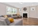 Cozy living room featuring a fireplace, large sectional sofa, and plenty of natural light at 31 Pascoli Ct, Clayton, NC 27527
