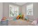 Bright playroom filled with toys and featuring two large windows at 31 Pascoli Ct, Clayton, NC 27527