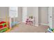 Inviting playroom featuring various toys and a pink vanity set at 31 Pascoli Ct, Clayton, NC 27527