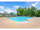 Community swimming pool with clear water, surrounded by lounge chairs and lush landscaping at 31 Pascoli Ct, Clayton, NC 27527