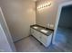 A bathroom featuring a granite countertop with dual sinks and tile floor at 311 W Market St, Graham, NC 27253