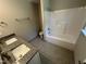Modern bathroom with double sink vanity, granite countertops, and a tiled shower and tub at 311 W Market St, Graham, NC 27253