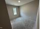 A bedroom with bare concrete floors and neutral paint at 311 W Market St, Graham, NC 27253