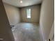A bedroom with bare concrete floors and neutral paint at 311 W Market St, Graham, NC 27253